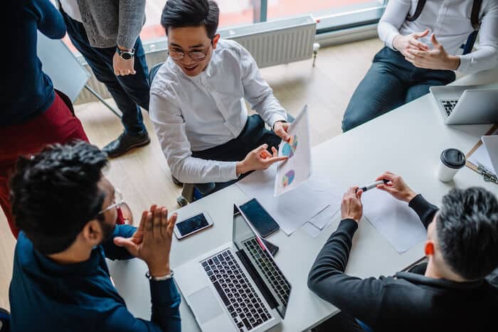 Employees talking about charts