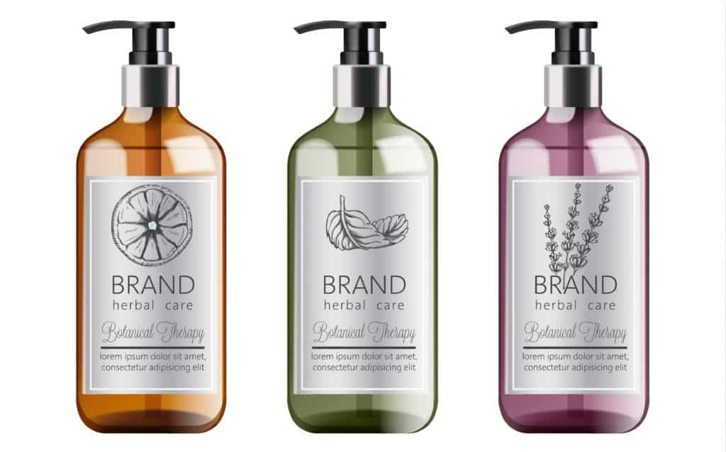 Bottles set of organic shampoo with herbal care. Various plants and colors. Mint, orange, and lavender.