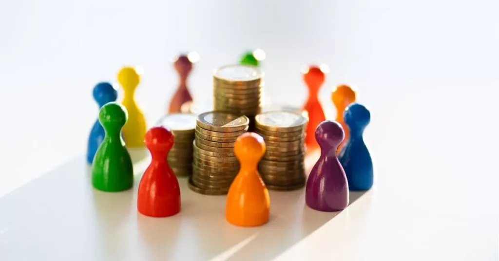 Crowd funding visual representing community backers gathered around stacked coins to fund a product idea.